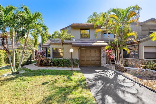 view of front of house featuring a garage and a front lawn