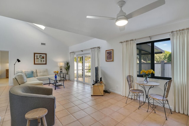 living room with ceiling fan, light tile patterned flooring, lofted ceiling, and french doors