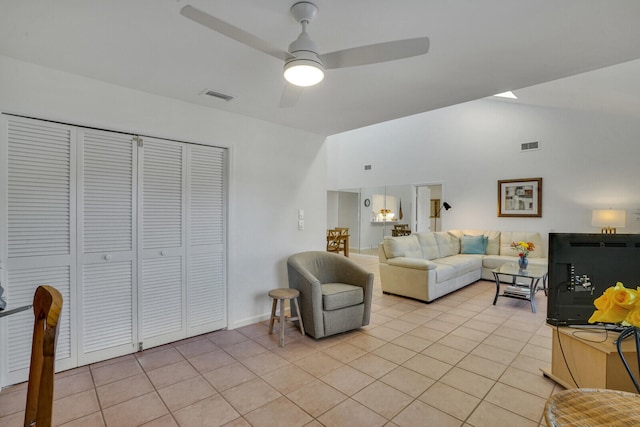 living room featuring light tile patterned floors, ceiling fan, and lofted ceiling