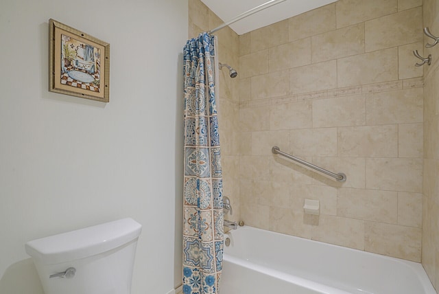 bathroom featuring shower / bath combination with curtain and toilet