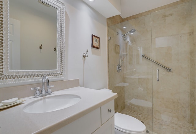 bathroom featuring vanity, toilet, and an enclosed shower