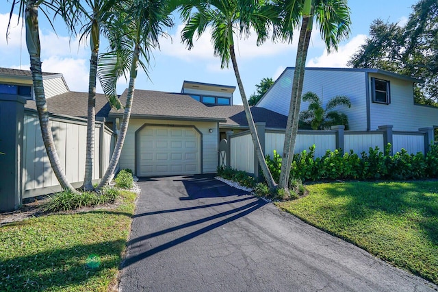 view of front of property with a garage and a front lawn