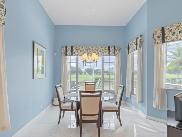 tiled dining room with a notable chandelier