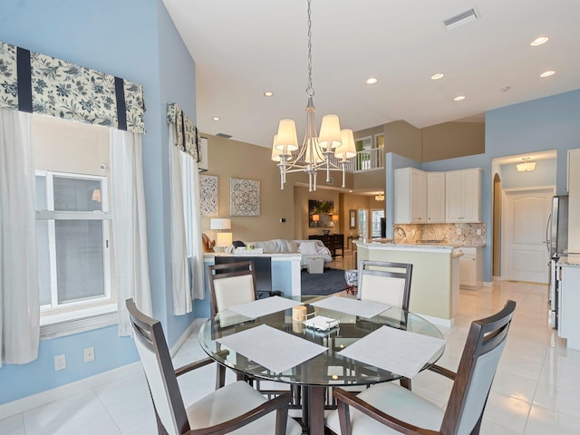 tiled dining space with sink and an inviting chandelier