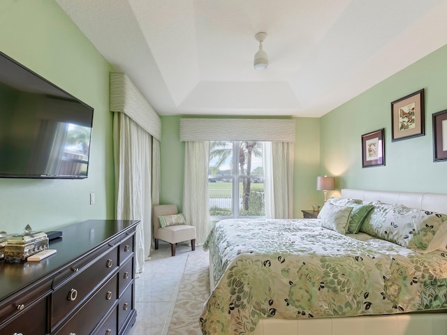 bedroom with a raised ceiling and ceiling fan