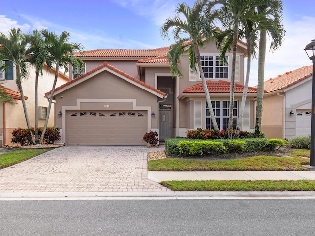 mediterranean / spanish-style home with a garage