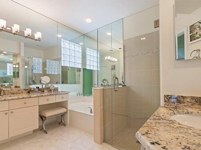 bathroom with tile patterned floors, vanity, and separate shower and tub