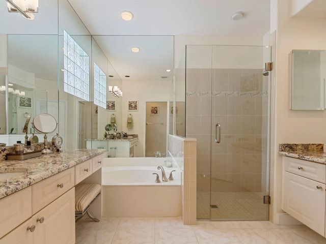 bathroom featuring separate shower and tub and vanity