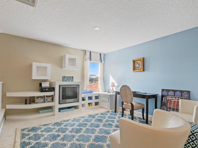 living area featuring a textured ceiling and carpet floors