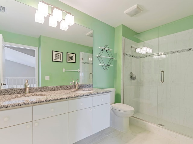 bathroom with vanity, toilet, and a shower with door