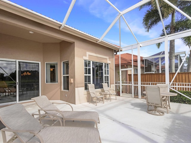 view of patio / terrace featuring glass enclosure