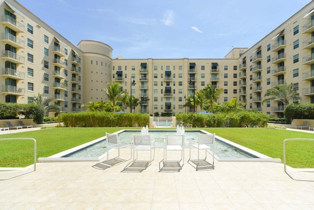 view of pool featuring a yard