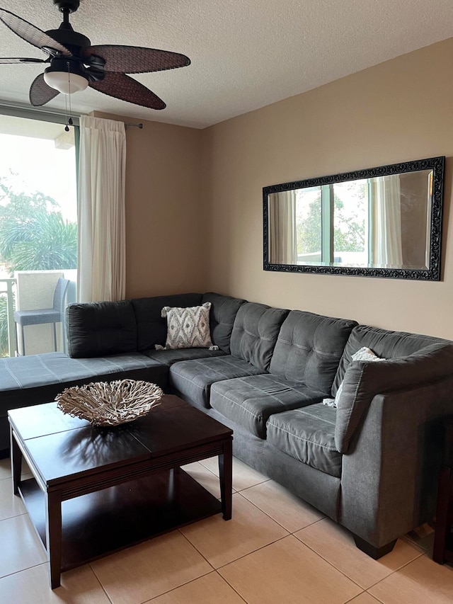 living room with light tile patterned floors, a textured ceiling, and ceiling fan