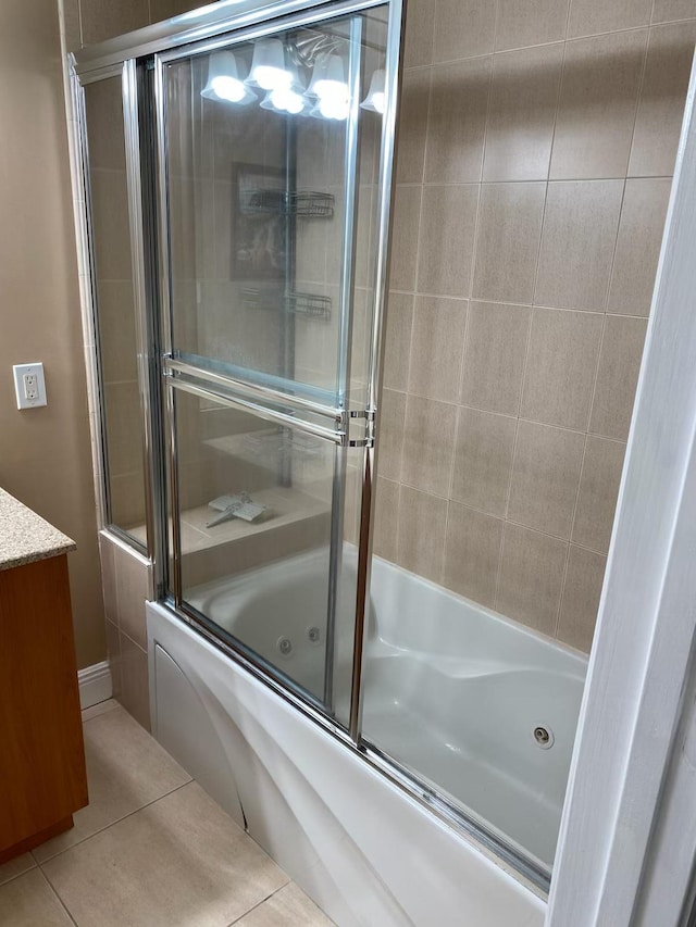 bathroom featuring tile patterned floors, vanity, and shower / bath combination with glass door