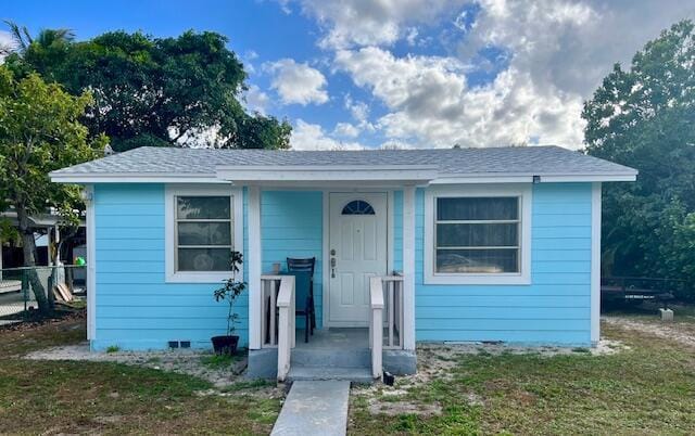 bungalow with a front yard