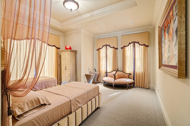 bedroom with a raised ceiling, crown molding, and carpet floors