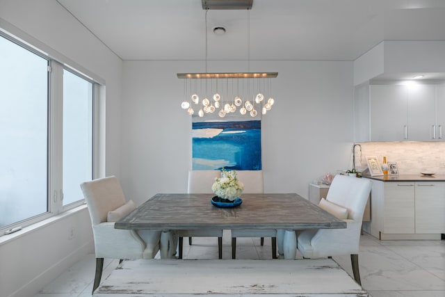 dining room with a healthy amount of sunlight and an inviting chandelier