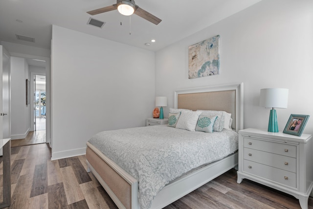 bedroom with ceiling fan and dark hardwood / wood-style floors