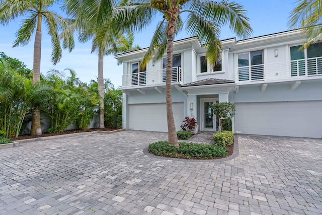 view of front of home featuring a garage and a balcony