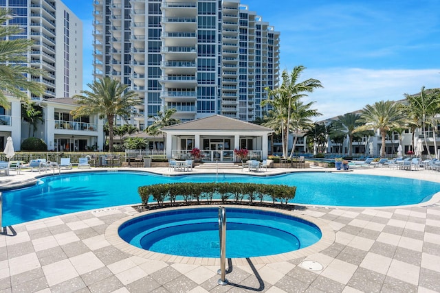 view of swimming pool with a patio and a hot tub