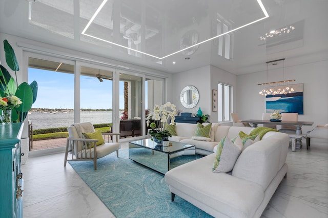 living room featuring a water view and a notable chandelier