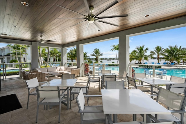 view of patio featuring an outdoor living space, ceiling fan, and a community pool