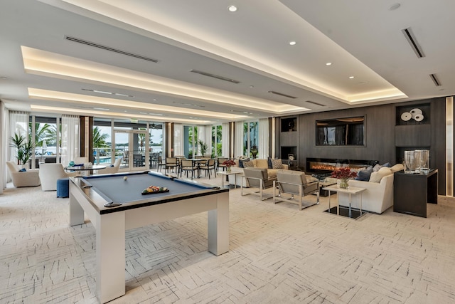 rec room featuring a raised ceiling and pool table