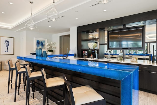 bar with hanging light fixtures and sink