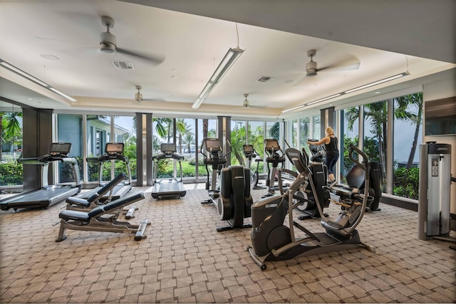 workout area featuring ceiling fan and light colored carpet