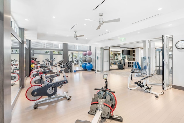 gym featuring ceiling fan and light hardwood / wood-style floors