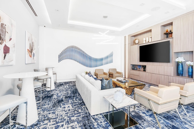 living room featuring a raised ceiling