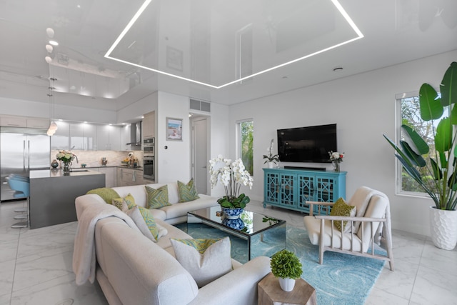 living room featuring a wealth of natural light and a towering ceiling