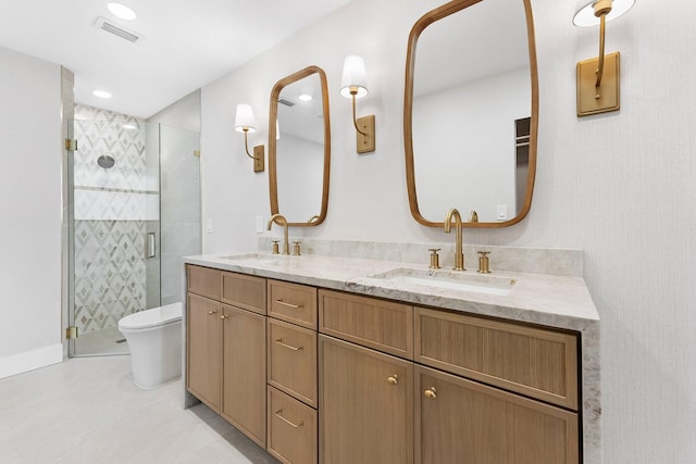 bathroom featuring vanity, toilet, and a shower with door