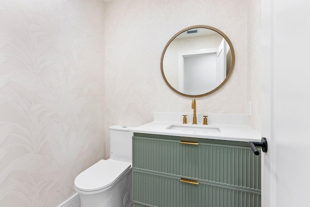 bathroom featuring vanity and toilet