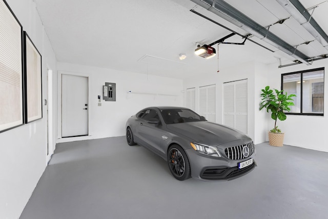 garage with a garage door opener and electric panel