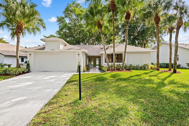 view of front of property with a front lawn and a garage