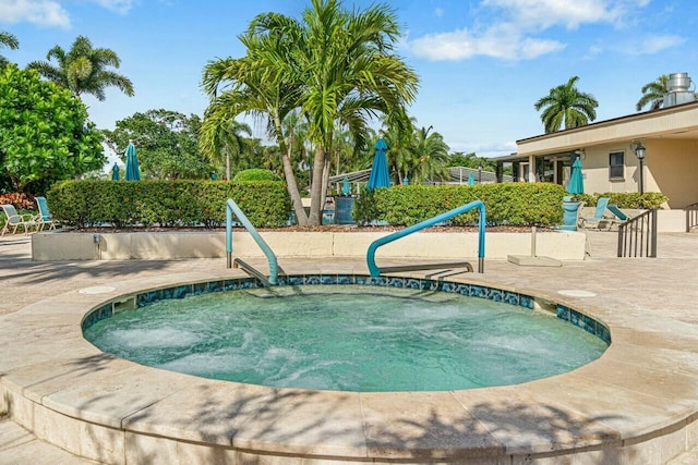 view of pool with an in ground hot tub