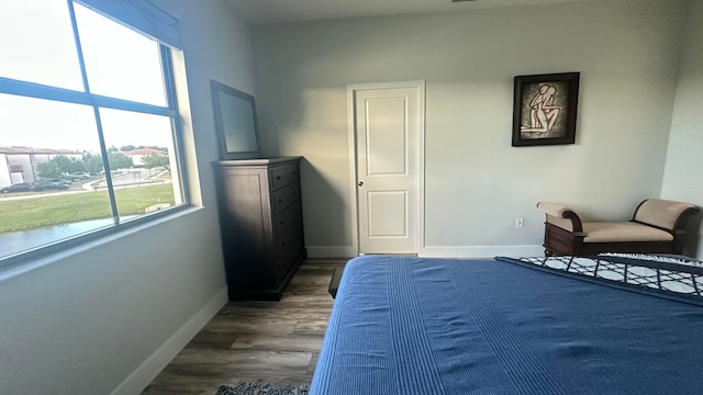 bedroom with dark hardwood / wood-style floors