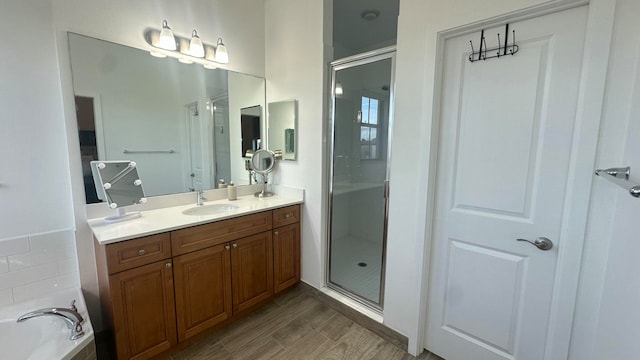 bathroom with vanity, hardwood / wood-style flooring, and separate shower and tub