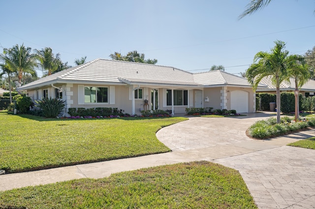 ranch-style house with a garage and a front lawn