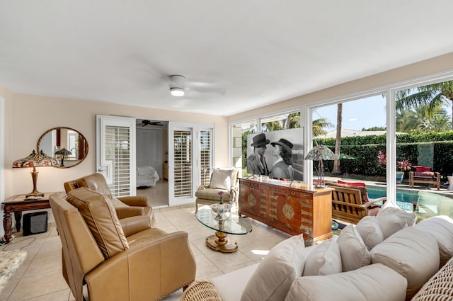 living room with ceiling fan and light tile patterned flooring