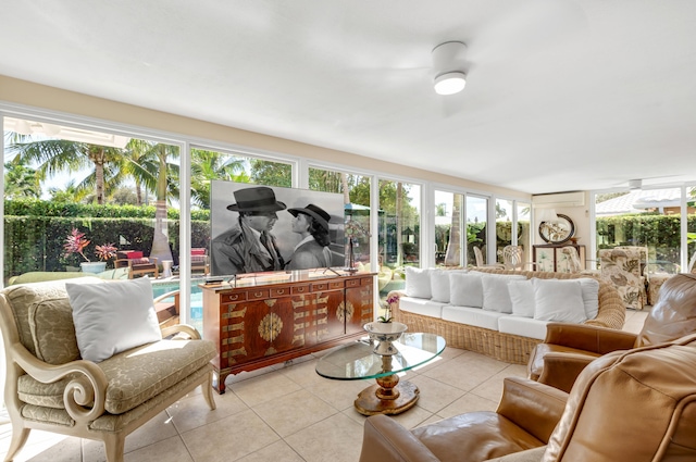 sunroom featuring an AC wall unit and a healthy amount of sunlight