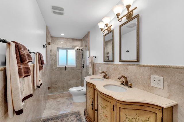 bathroom featuring vanity, a shower with shower door, tile walls, and toilet