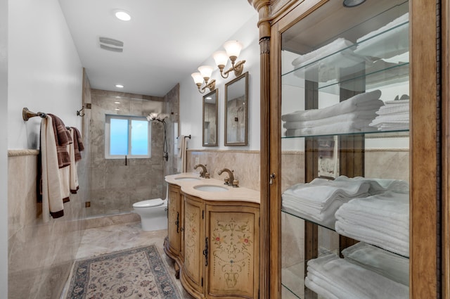 bathroom featuring tiled shower, toilet, tile walls, and vanity