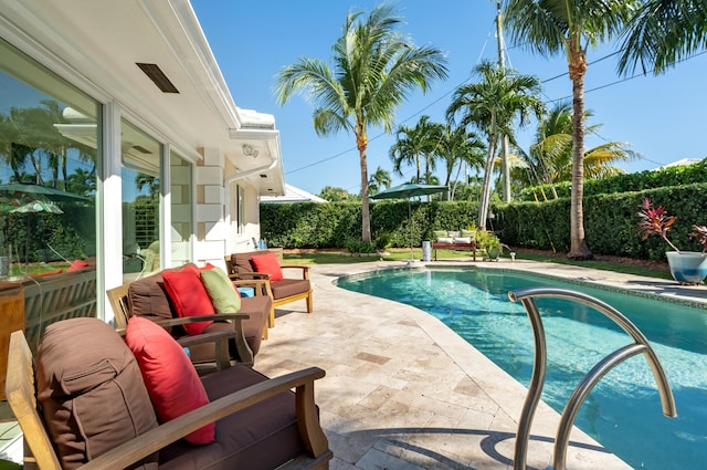 view of swimming pool with outdoor lounge area and a patio