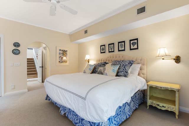 bedroom featuring ceiling fan, crown molding, and light carpet