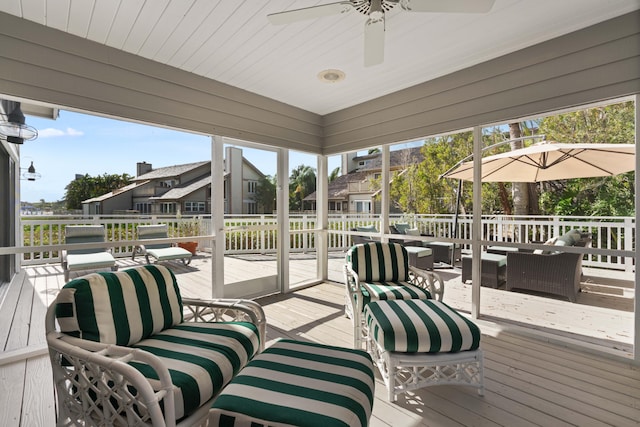 wooden terrace with an outdoor living space and ceiling fan