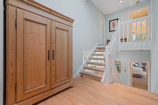 stairs featuring hardwood / wood-style flooring and a baseboard radiator