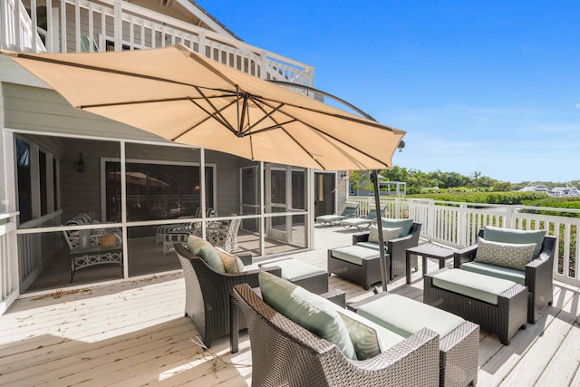 deck featuring an outdoor living space and a sunroom