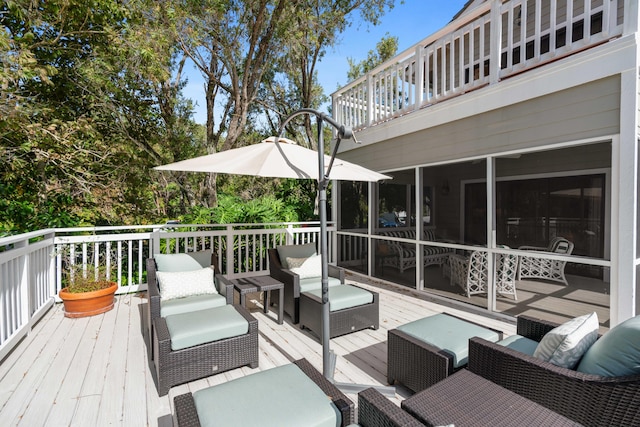 deck featuring a sunroom and outdoor lounge area